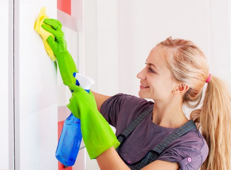 Cleaning technician preparing carpet cleaning equipment in a home interior