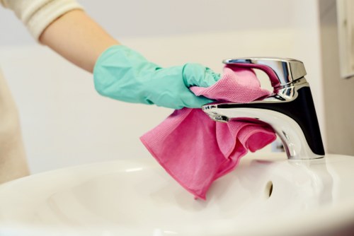 Carpet cleaning team preparing equipment with safety precautions