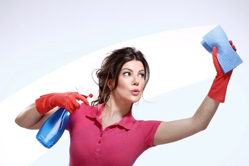 Cleaning staff sanitising desks and shared office surfaces